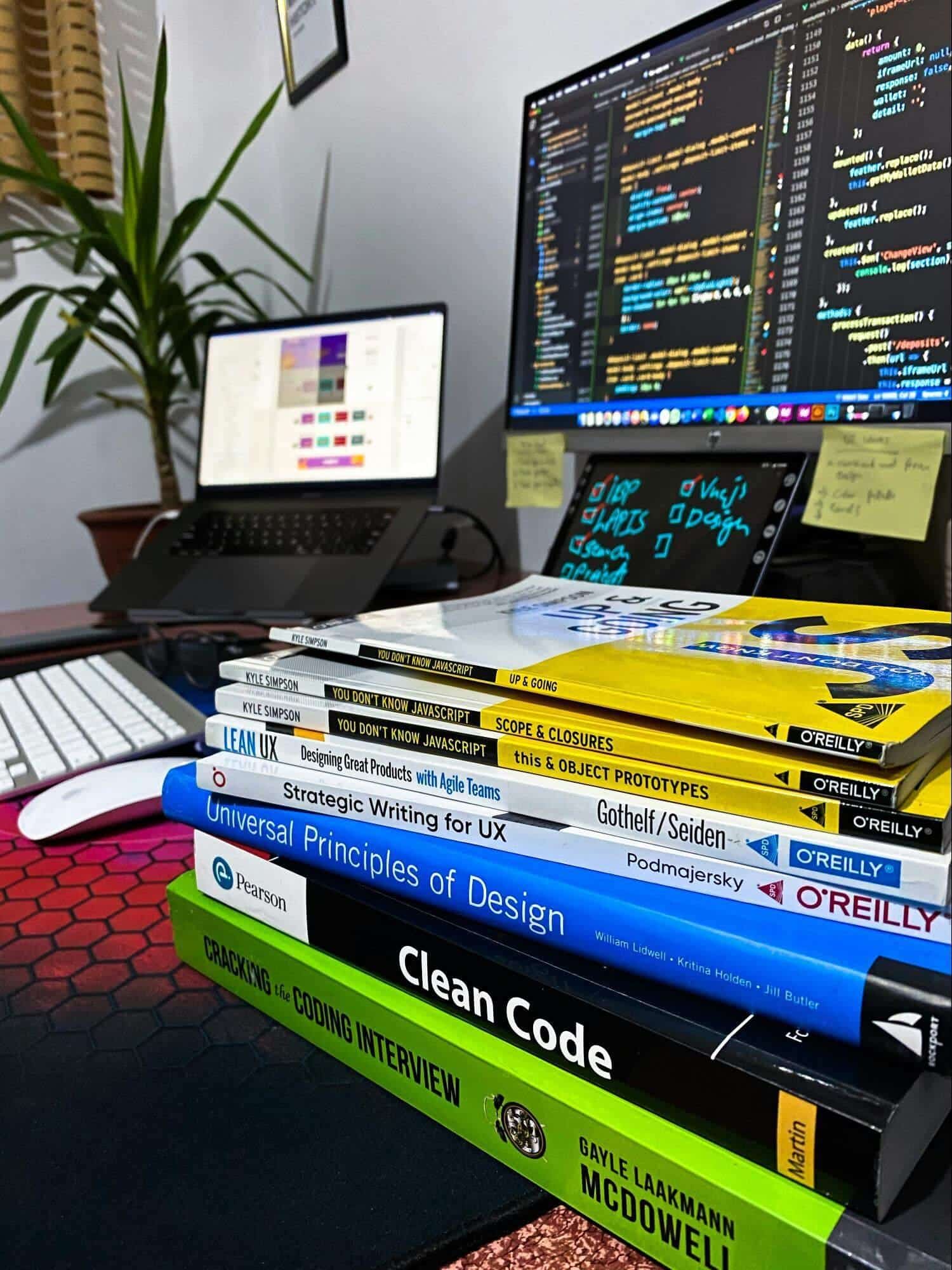 Stack of books with computer in background