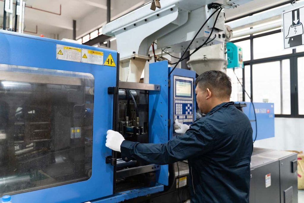 Worker operating automated metal fabrication machinery